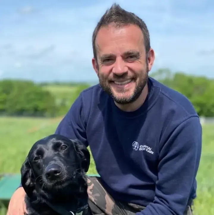 Seb Byrd, founder of Capital Dog Care, with a dog