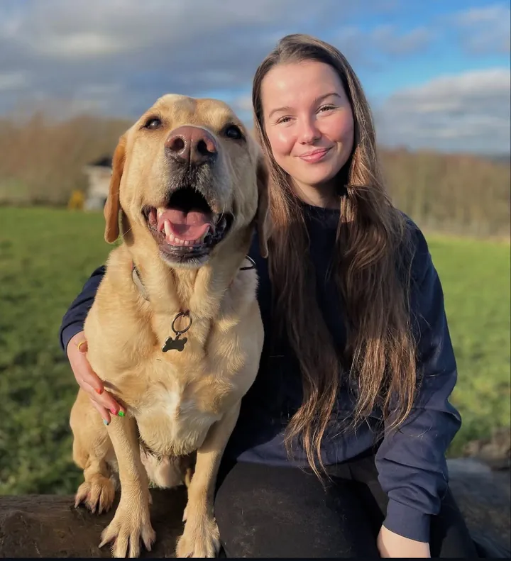 Taz, Day Care Assistant, with a dog
