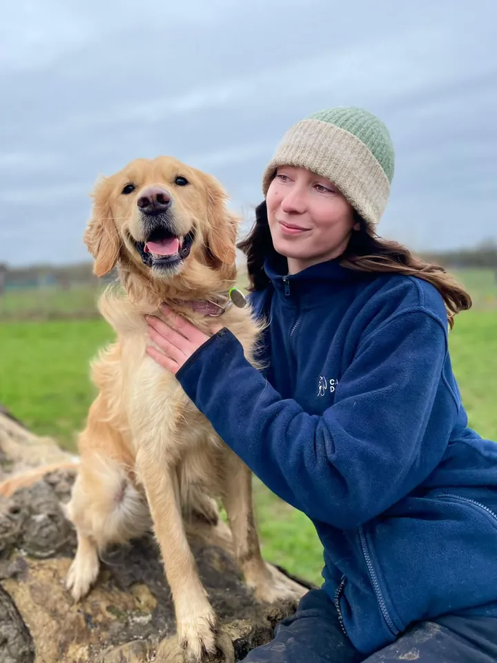 Megan, Day Care Assistant, with a dog
